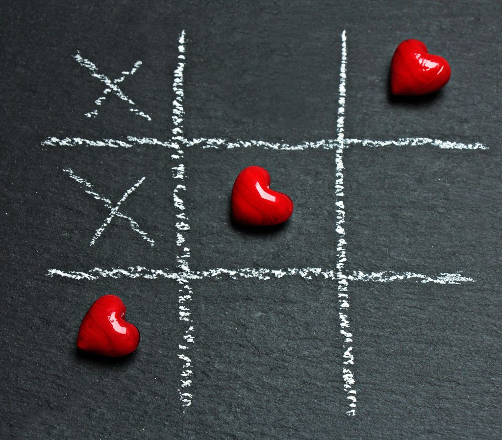 pexels photo 220057 220057 Chalkboard tic tac toe game with red heart shapes symbolizing love and strategy.
